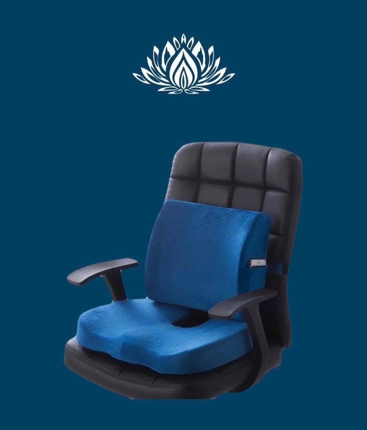 An orthopedic seat cushion in blue color fitted on a black office chair with a floral pattern in the background.
